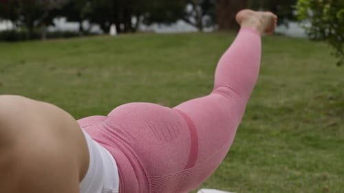 Leg buttock exercises workout outdoors, young woman doing yoga in the park