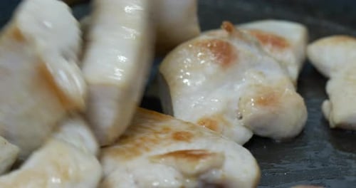 Pieces of Chicken Cooking in Pan Close Up