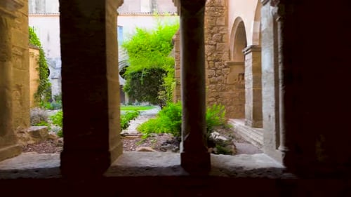 Slow motion dolly shot of archways revealing the beautiful garden courtyard