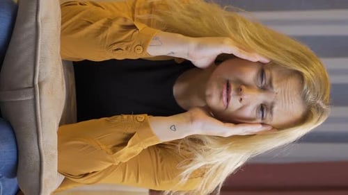 Adult Woman Suffering From a Headache Indoors