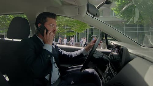 Man Talking on Phone in Car, Daytime Urban