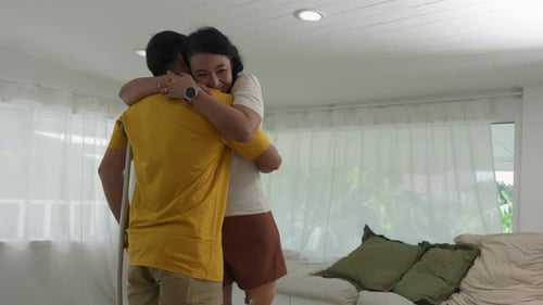 Heartwarming Hug Between Woman and Young Man with Crutch