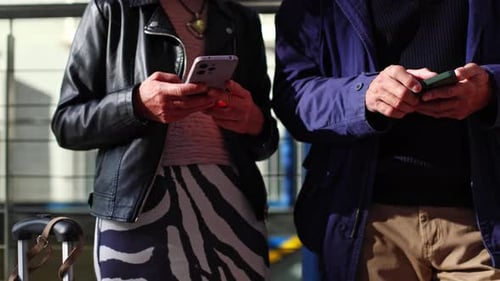 Group of People Standing Together Using Smartphones