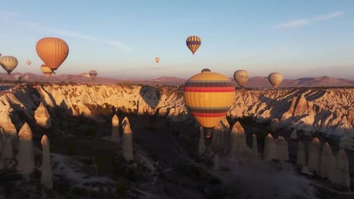 Goreme, Turkey - 01 December 2024: Aerial view of hot air balloons at sunrise, Turkey.