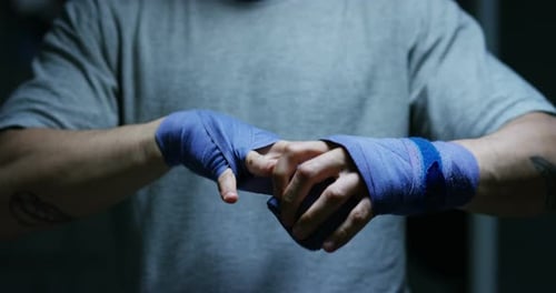 Boxer Wrapping Hands with Blue Boxing Wraps