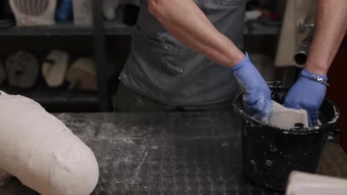 Craftsman Preparing Leg Plaster Cast in Workshop