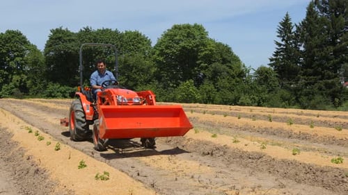 Man Driving Tractor on Farm Agricultural