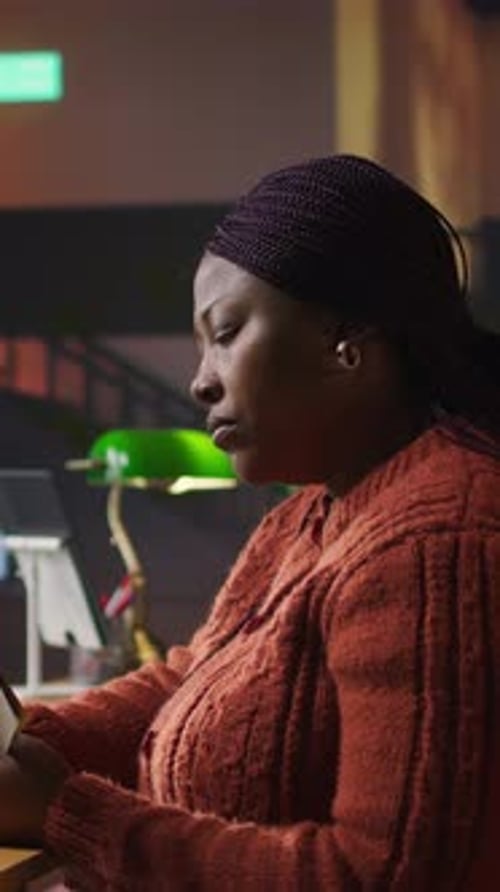 Vertical Video Confident Tutor Reading Notes and Preparing Teaching Materials at a Library Desk
