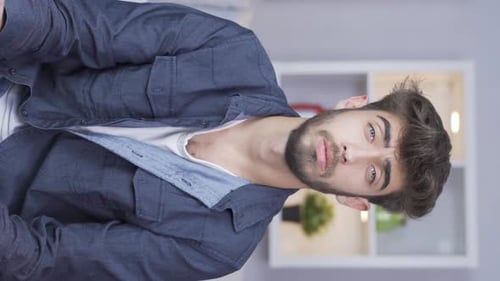 Young Adult Man Talking to Camera Indoors