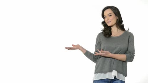 Attractive woman presenting or advertising against white background