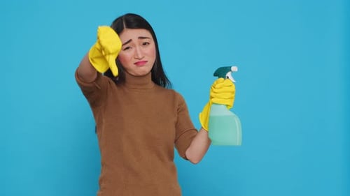 Woman Giving Thumbs Down with Cleaning Bottle