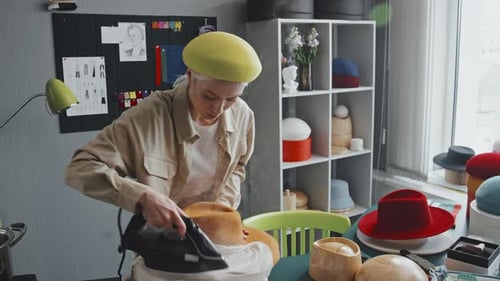 Woman Steams Hat in Bright, Creative Studio