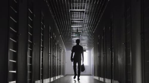 Man Walking Down Dark Hallway Silhouette
