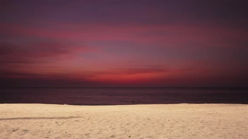 Sandy Beach With Vibrant Sky At Dusk In The Background In Santa Marta, Colombia. - wide shot