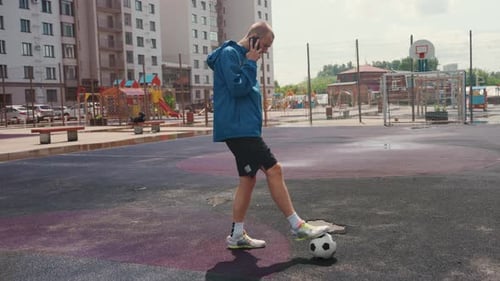 Urban Athlete Plays Under Rain Solo Soccer Training in Rainy City Environment Lone Player Practices