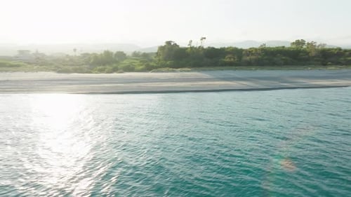 Calm Ocean of Tropical Beach Under Cloudy Sky