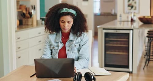 Woman Working on Laptop at Table