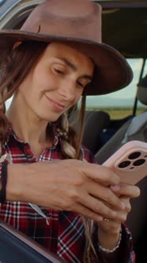 An Explorer Enjoying a Beautiful Scenic Drive While Using Her Mobile Phone to Capture Moments