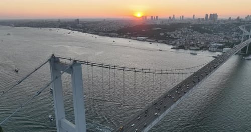 Istanbul Bosphorus Bridge and City Skyline in Background with Turkish Flag at Beautiful Sunset