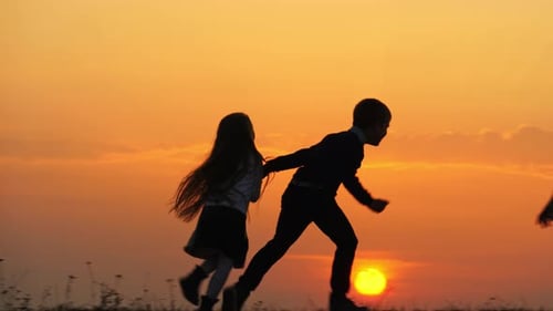 Brother and Sister Play with Father at Sunset