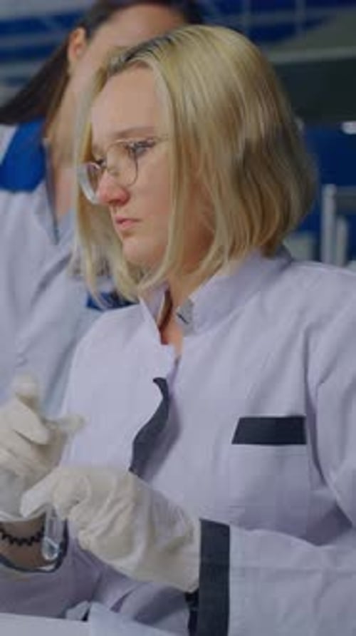 Woman Scientist Working with Test Tube in Laboratory