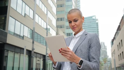 Woman Using Tablet in Modern Urban Setting