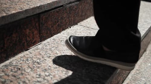 Slow Motion Footage of Men's Legs Rising A Businessman is in a Hurry to Get to Work A Sunny Day in