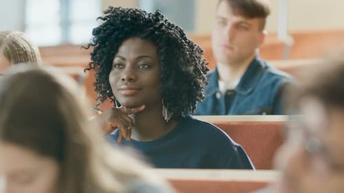 Focused students listening in lecture hall classroom