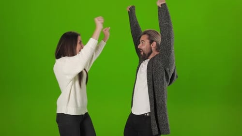 Man and Woman Celebrating Their Success with Gestures