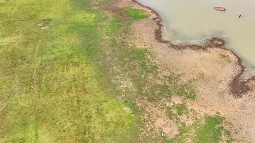 Aerial view showing a dam's water body with adjacent dry.