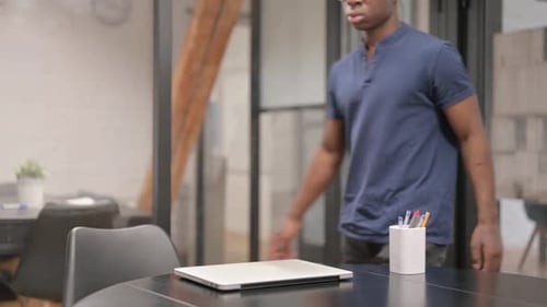 Young Adult Arriving at Modern Office Desk