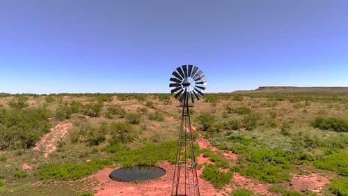 Windmill and Watering Hole on Rural Texas Landscape