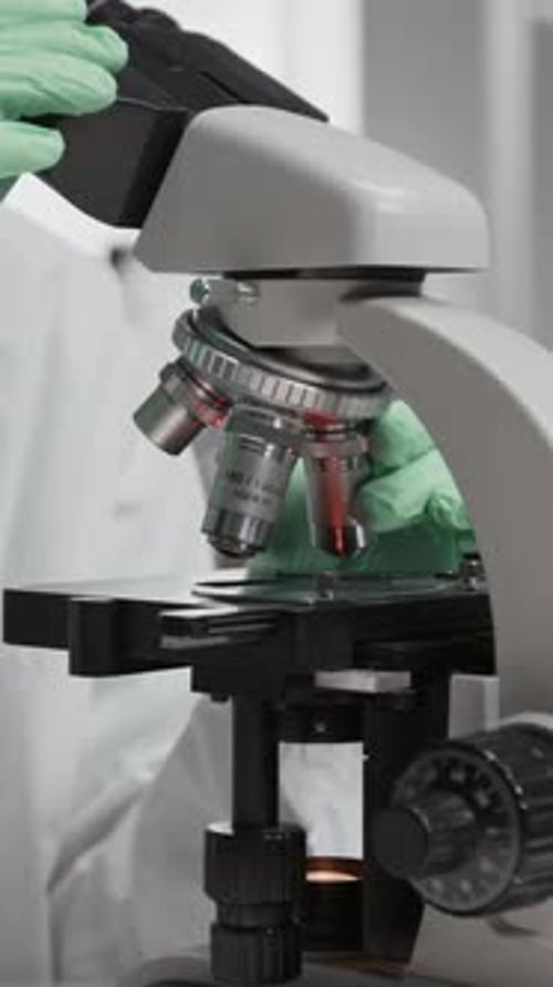 Microscope Close-up in Laboratory with Scientist