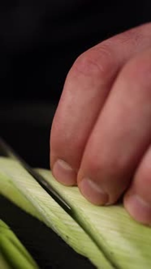 the chef cuts vegetables in a restaurant