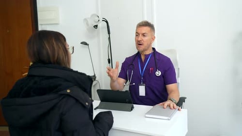 Professional Physician Explaining Diagnosis to Patient in Clinic Office