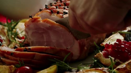 Cutting Festive Ham with Cloves and Pomegranate