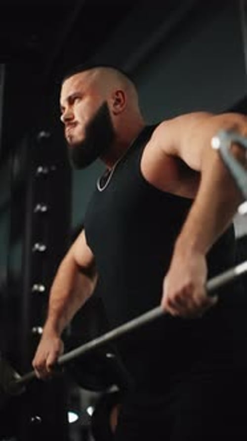 Muscular Bodybuilder Executing Powerful Barbell Rows Showcasing Remarkable Strength During Rigorous