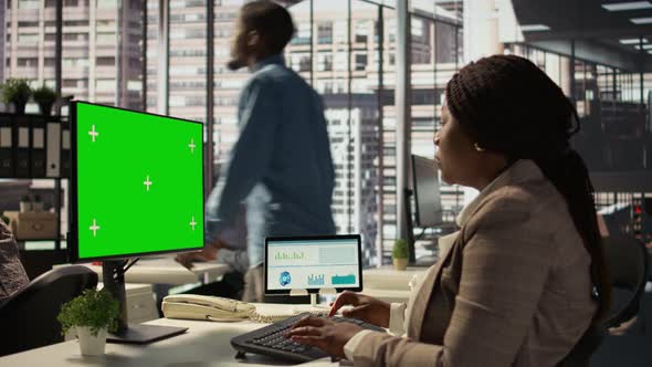 Female Director Seated at Workstation with Green Screen on Devices ...