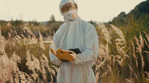 A Scientist Dressed in Protective Gear is Actively Conducting Essential Field Research