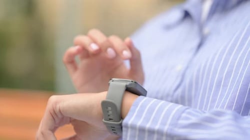 Close up of Hispanic Woman Using Smart Watch Outdoor