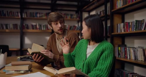 Students Studying Together in Library Stacks