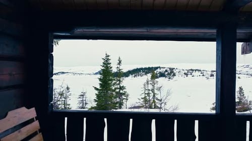 Terrace of Wooden Cabin Overlooking The White Landscape During Winter. - aerial pullback shot