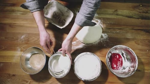 Male Hands Preparing Dough for Bread on Table Top View