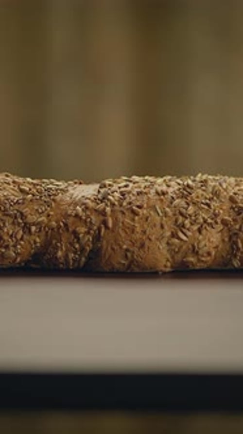 Seedy bread sitting on a wooden table