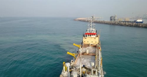 Aerial footage over Sand dredging ship with Ashdod port on Background