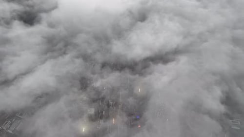 Aerial view of urban landscape shrouded in clouds, Hong Kong.
