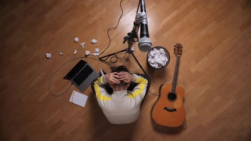 Musician struggles with writer's block in studio apartment
