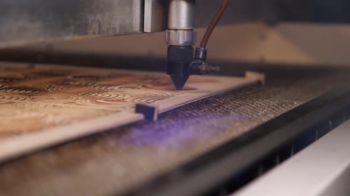 Laser Engraving Machine Cutting Elaborate Pattern into Wood