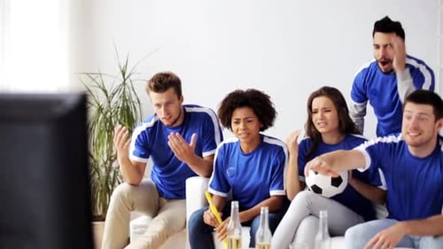 Friends watch a soccer game at home disappointed by losing team in slow motion