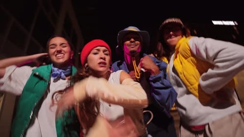 Energetic Young Adults Dancing Together in Urban Setting